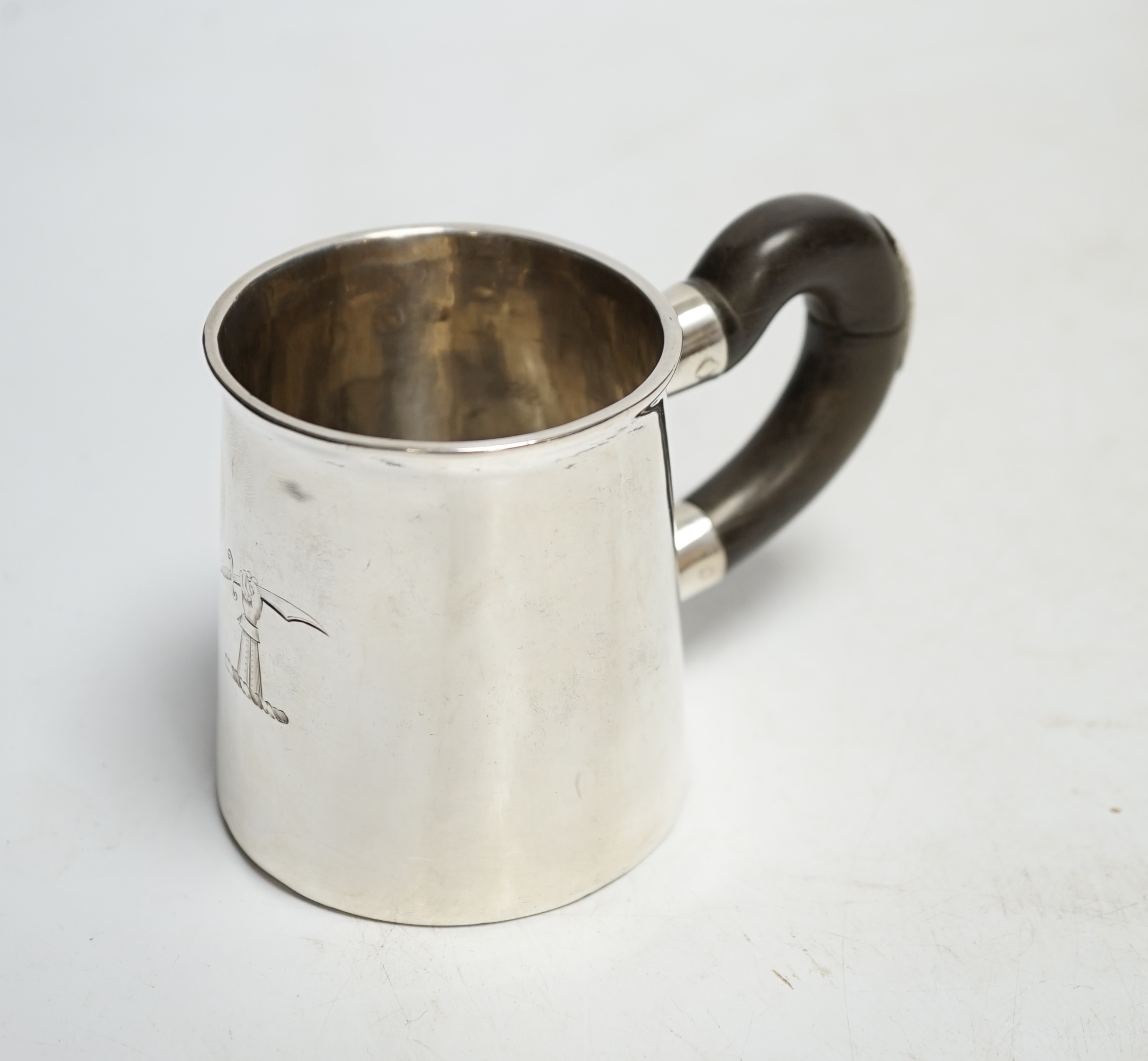 An early 18th century silver mug, with wooden handle, marks rubbed, height 78mm. Condition - poor